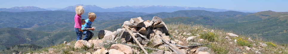 Kids on top of a mountain